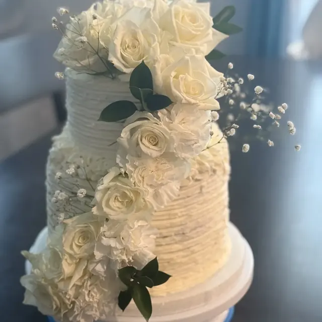 Two-tier cake with fresh white roses